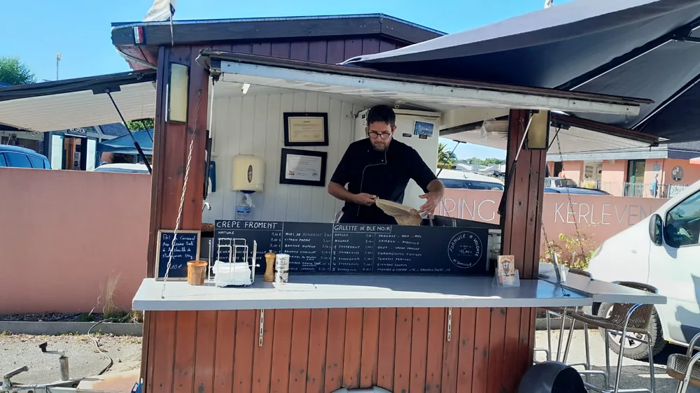 Arnaud Moalic prépare les crêpes au comptoir de la roulotte, dans un camping